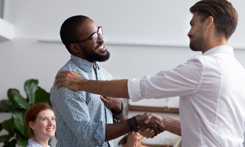 Sales leader rewarding top performer in a sales kick off